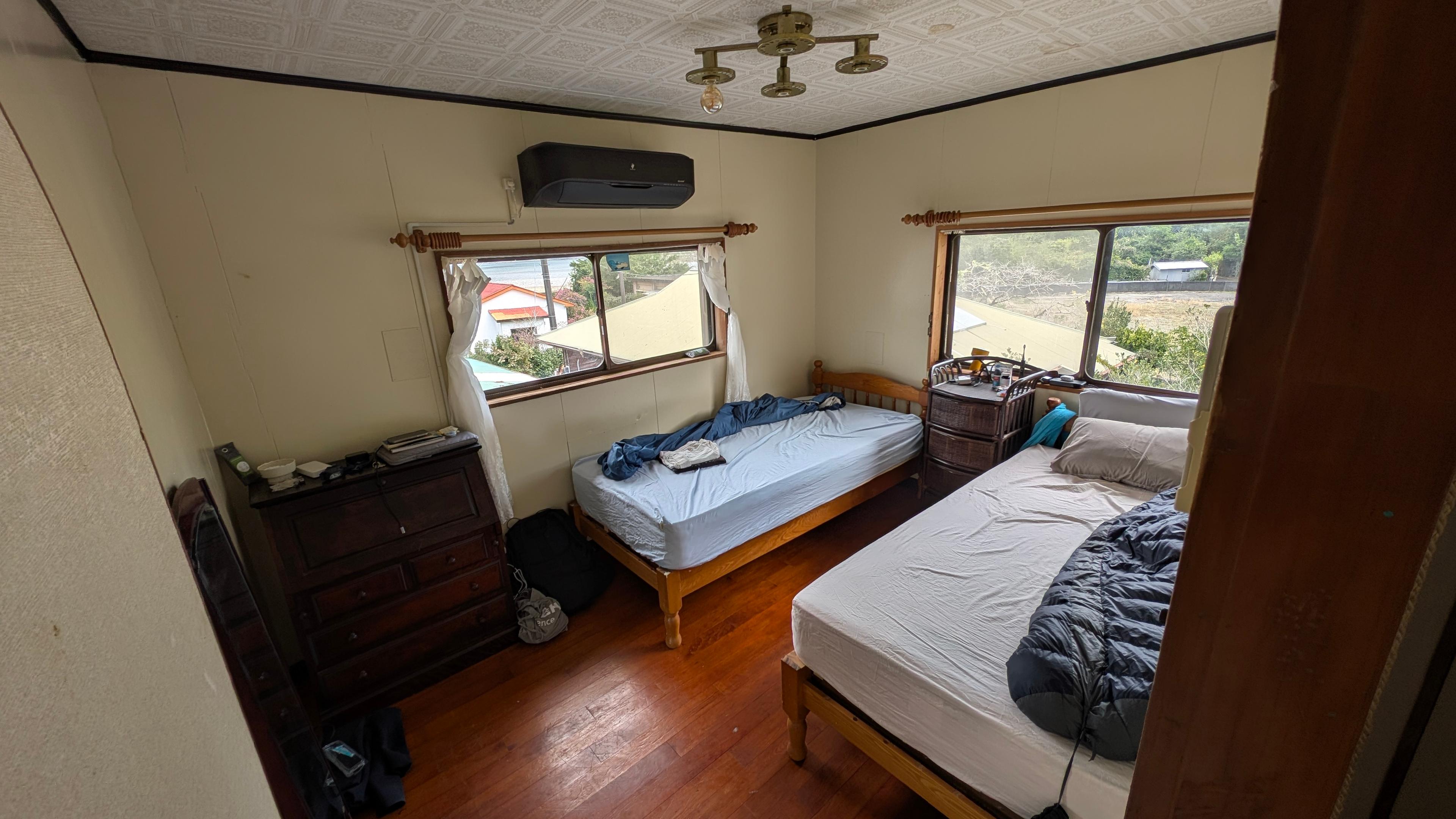 IKADA bedroom with twin beds and wooden floors