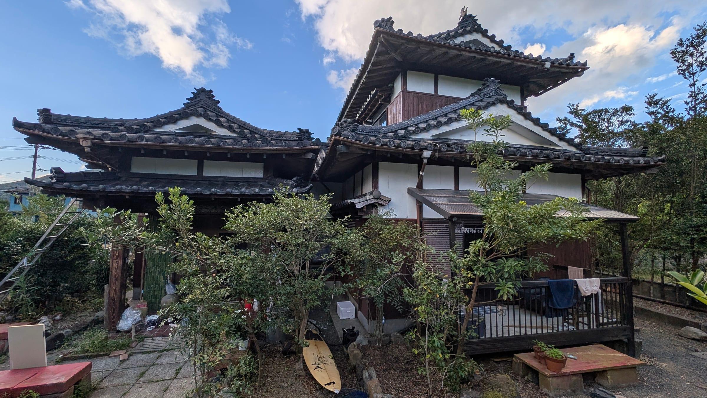 The IKADA house, a tiled-roof home in a garden